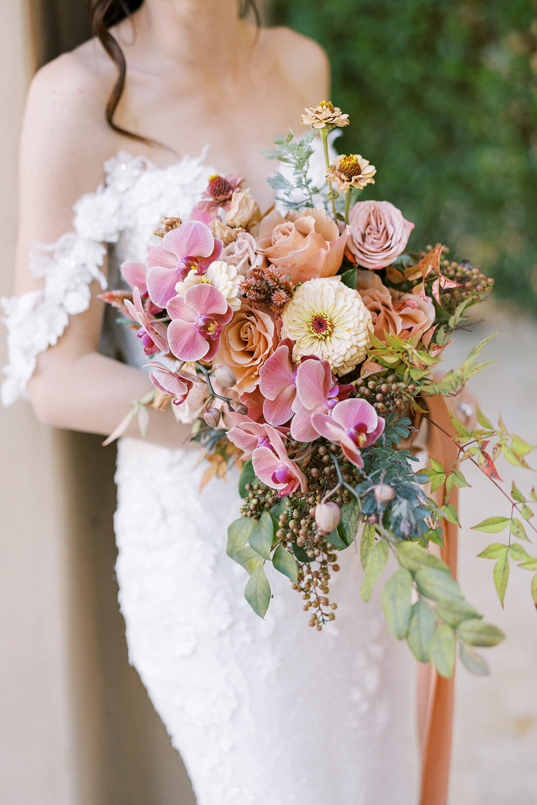 Romantic bridal bouquet overflowing with blush orchids, garden roses, and textured greenery—artful, elegant, and full of emotion.