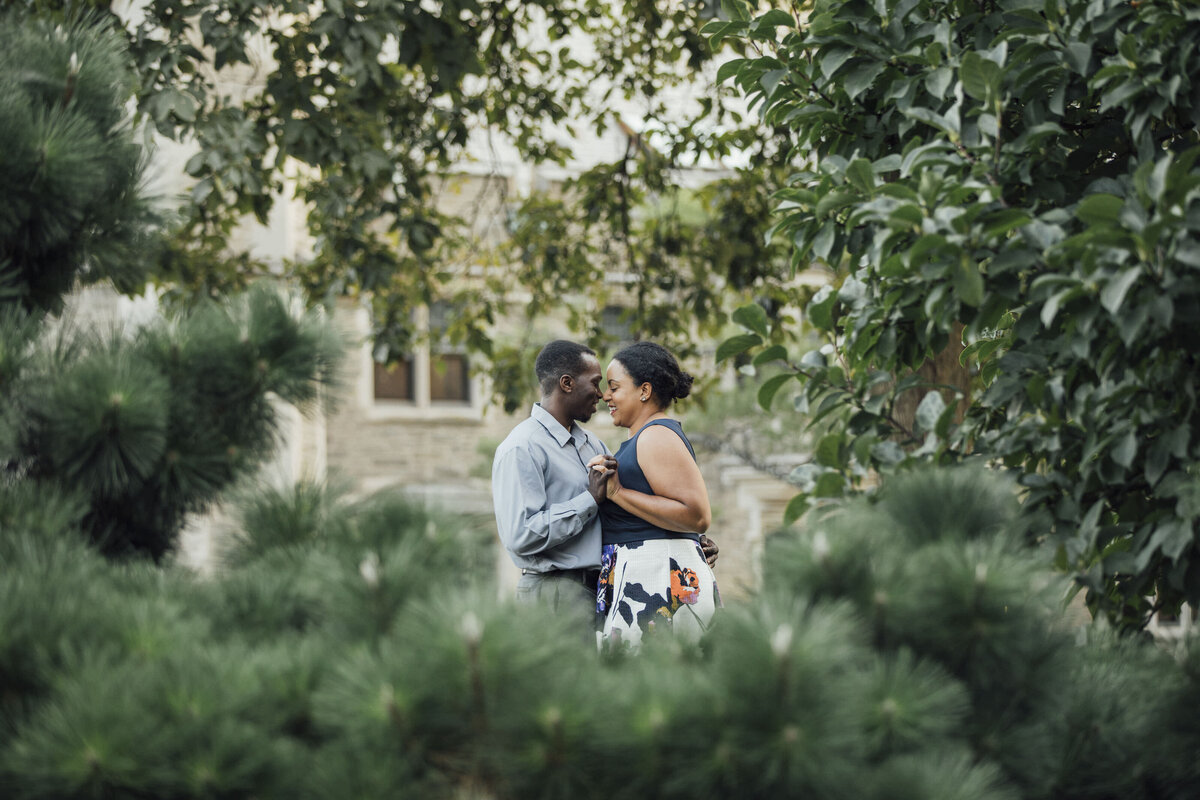 Couple posing by stone building during engagement session at Princeton University New Jersey