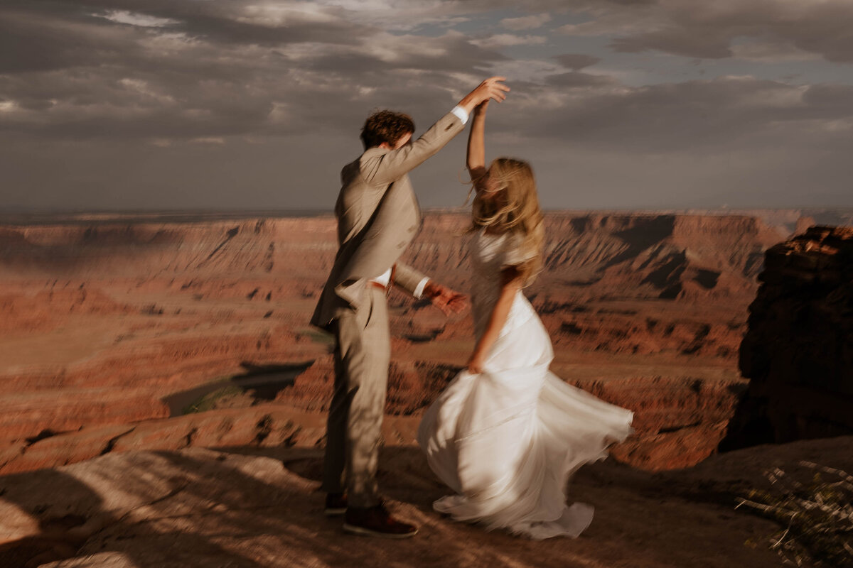 Outdoor dessert photo of bride and groom dancing 