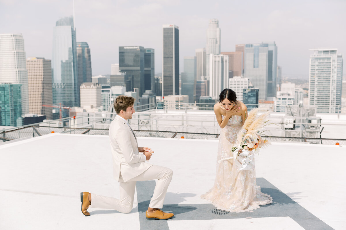 A breathtaking rooftop proposal with the Los Angeles skyline setting the stage for a moment of pure romance.