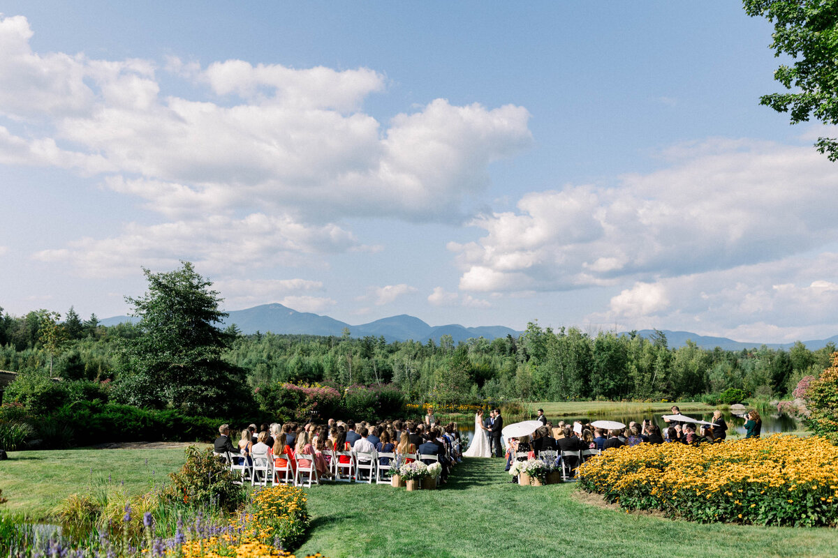 wide  shot of ceremony iwith mountains and flowers