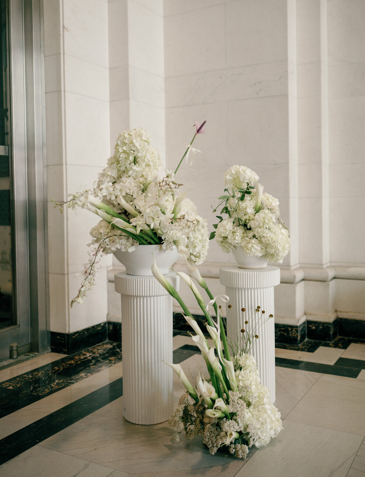 Unique floral arrangements rest atop pillars at State Savings Bank, Detroit