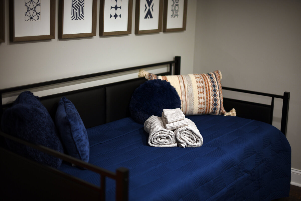 Close up of professionally staged rolled towels on bed