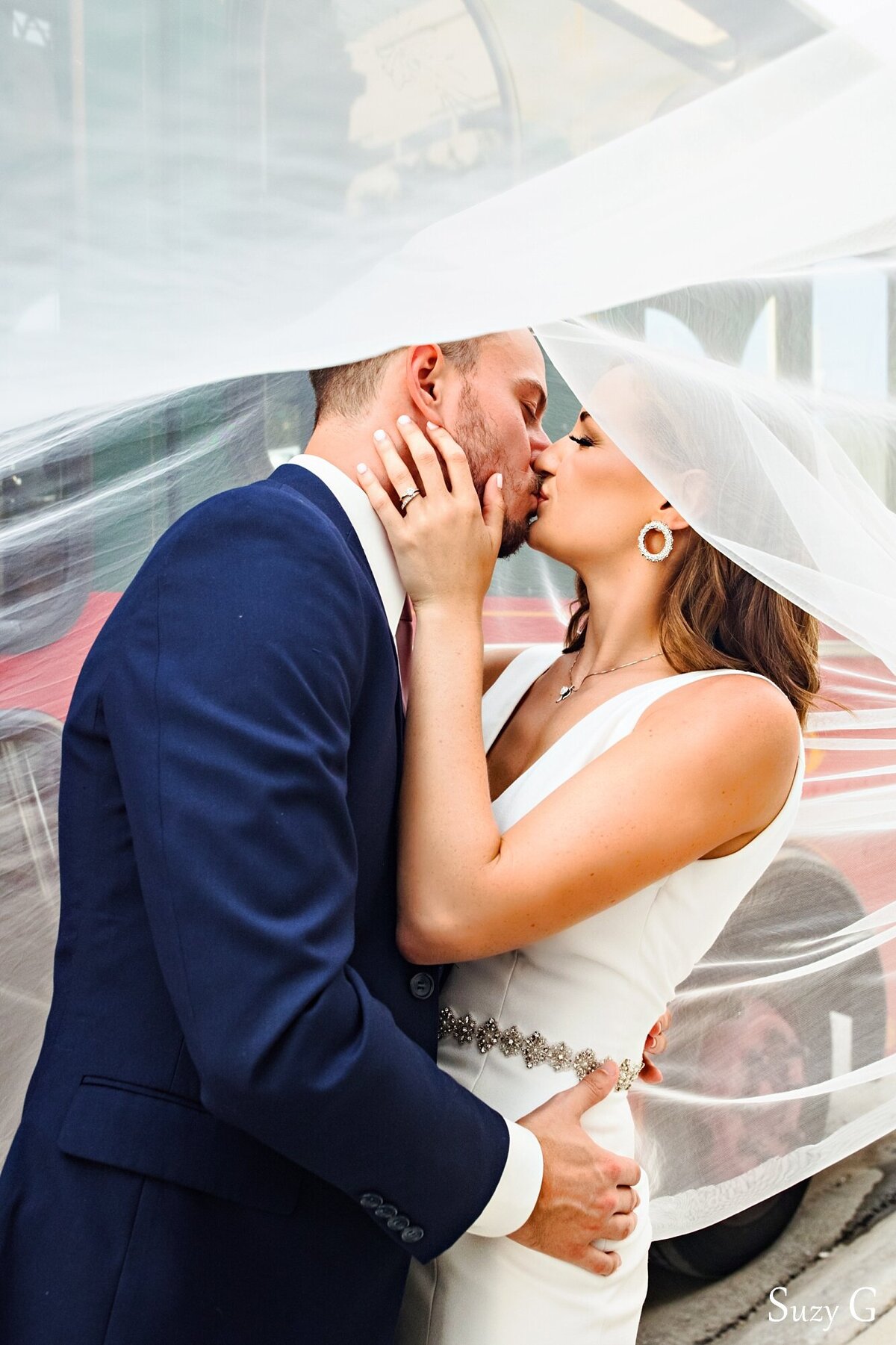 This gorgeous under the veil shot captures the sweet intimate moment of a kiss between the bride and groom.