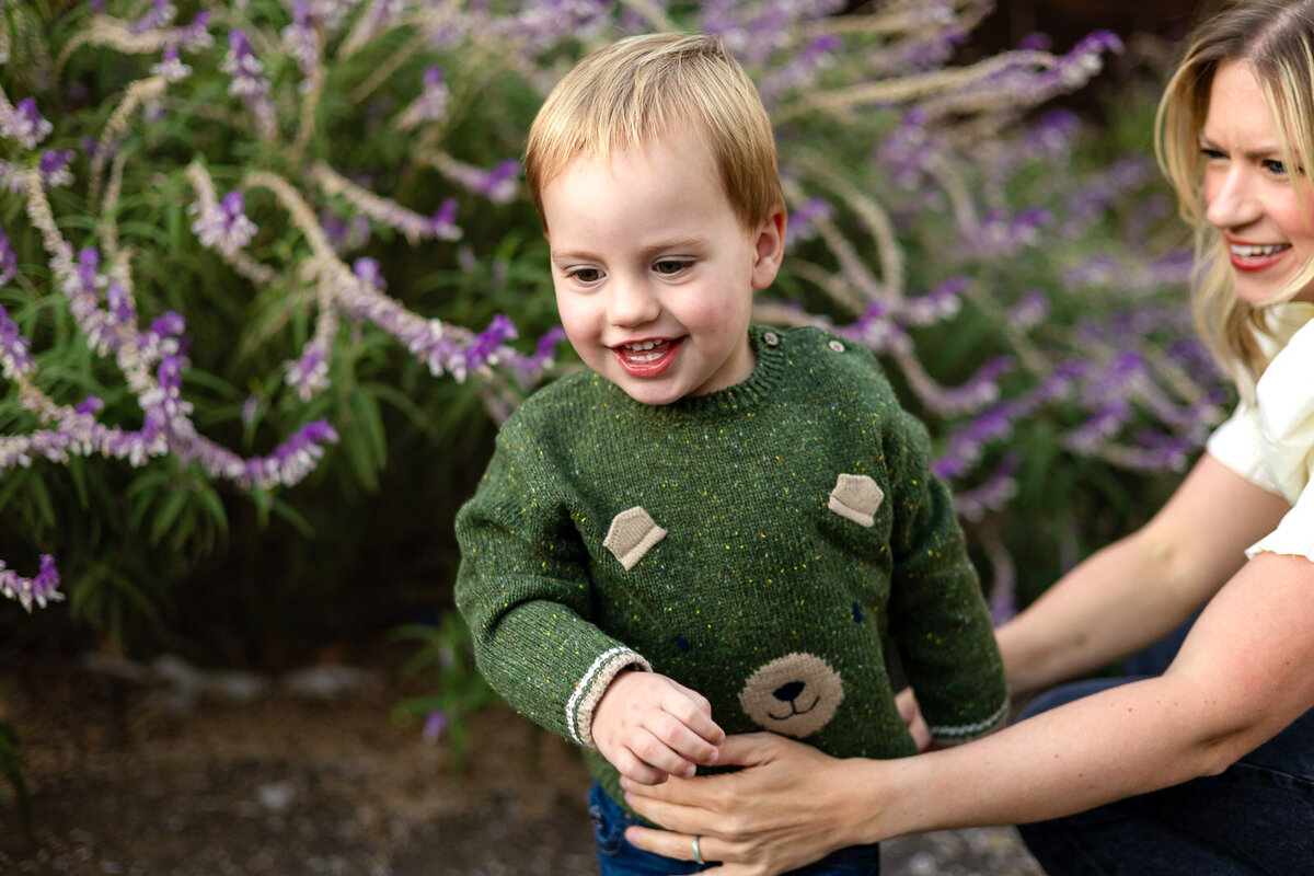 Laughing toddler in bear sweater playing outdoors – Bay Area Family Portfolio by Ellobelle Photography