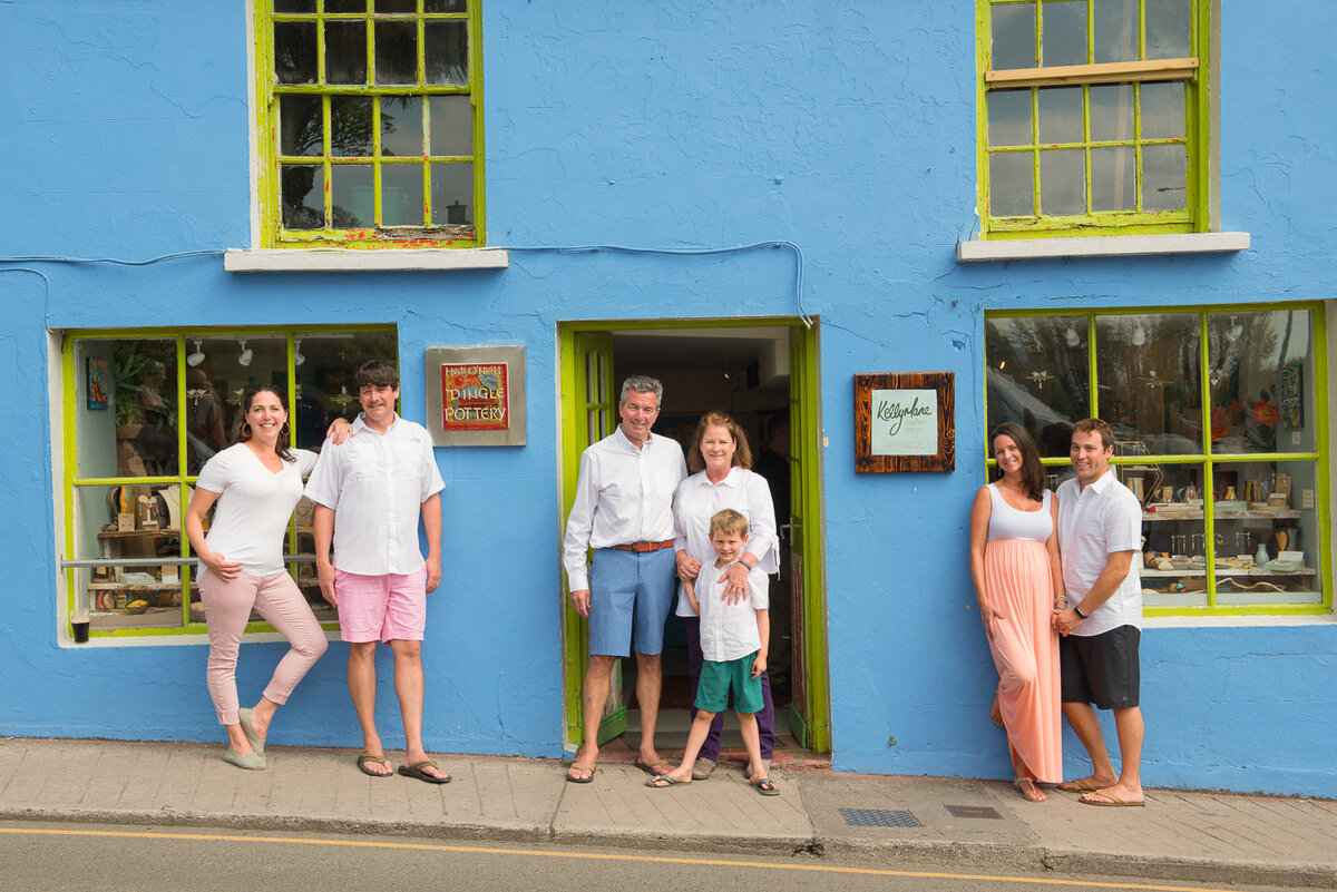 colourful three generation family portrait outside a shop in Dingle