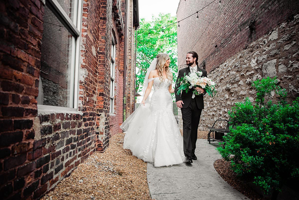 Couple strolling together outside of Cannery  in a quaint alley