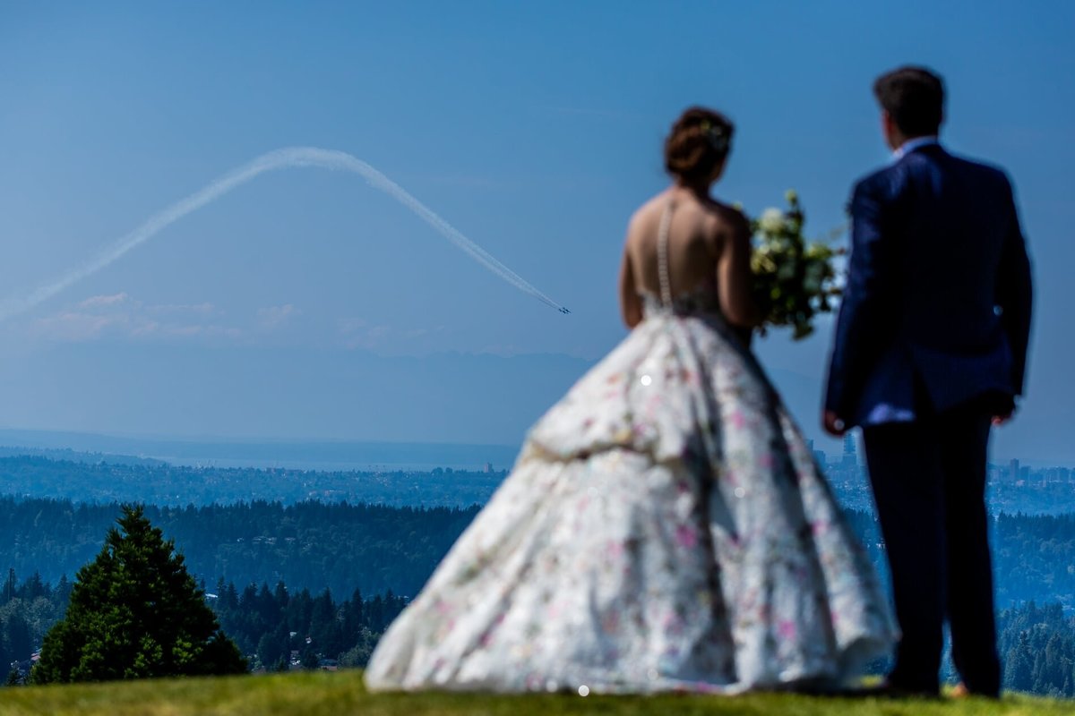 Bride and groom looking out over Puget Sound and Blue Angels performance