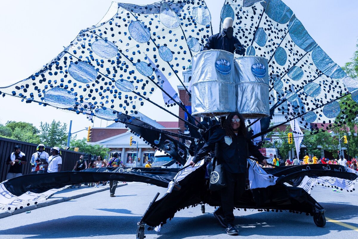 Toronto caribbean carnival parade masqueraders having fun in costume with Sunlime Mas, the number 1 medium size band at Toronto Carnival.