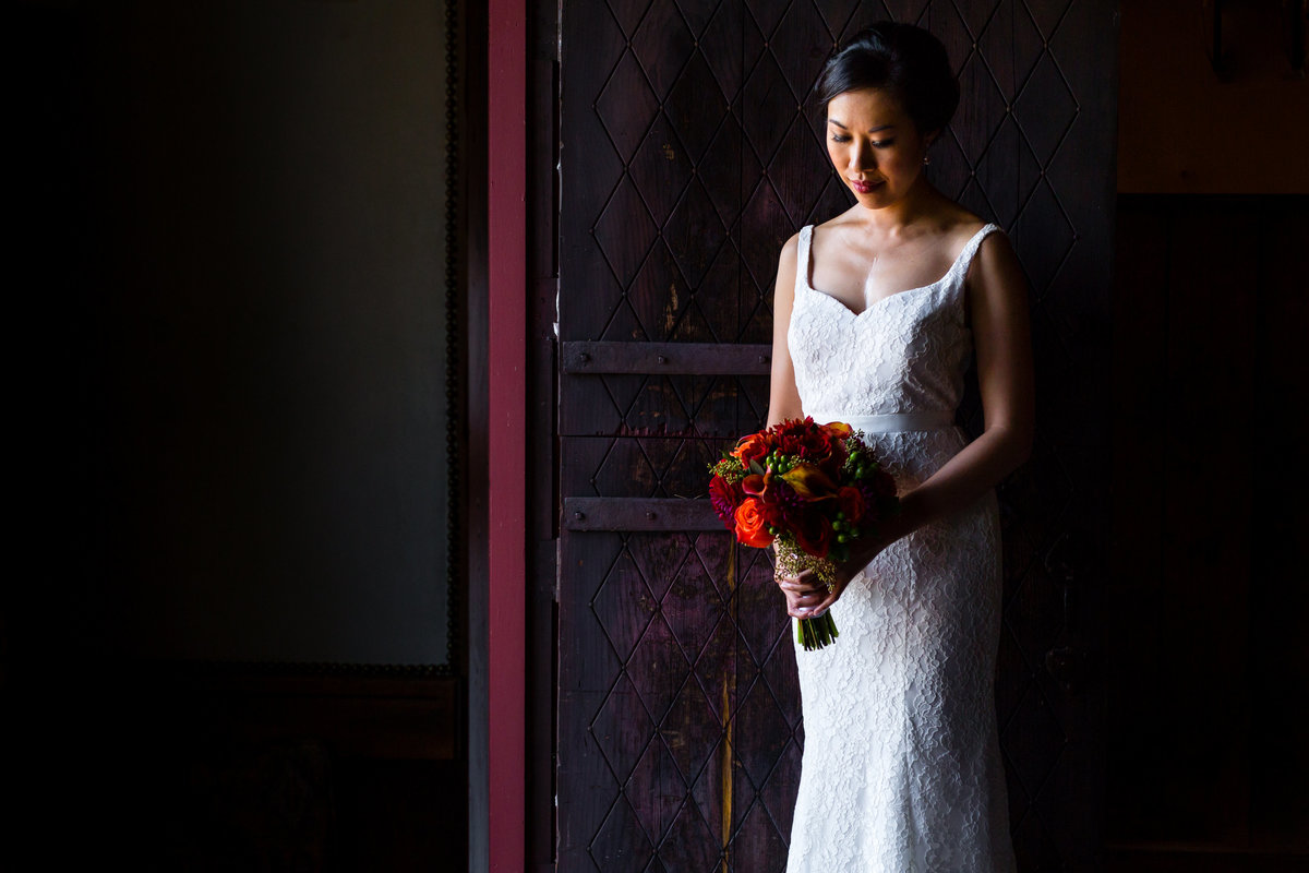 The bride hold her flowers at the Barn at Crane Estate in Ipswich MA