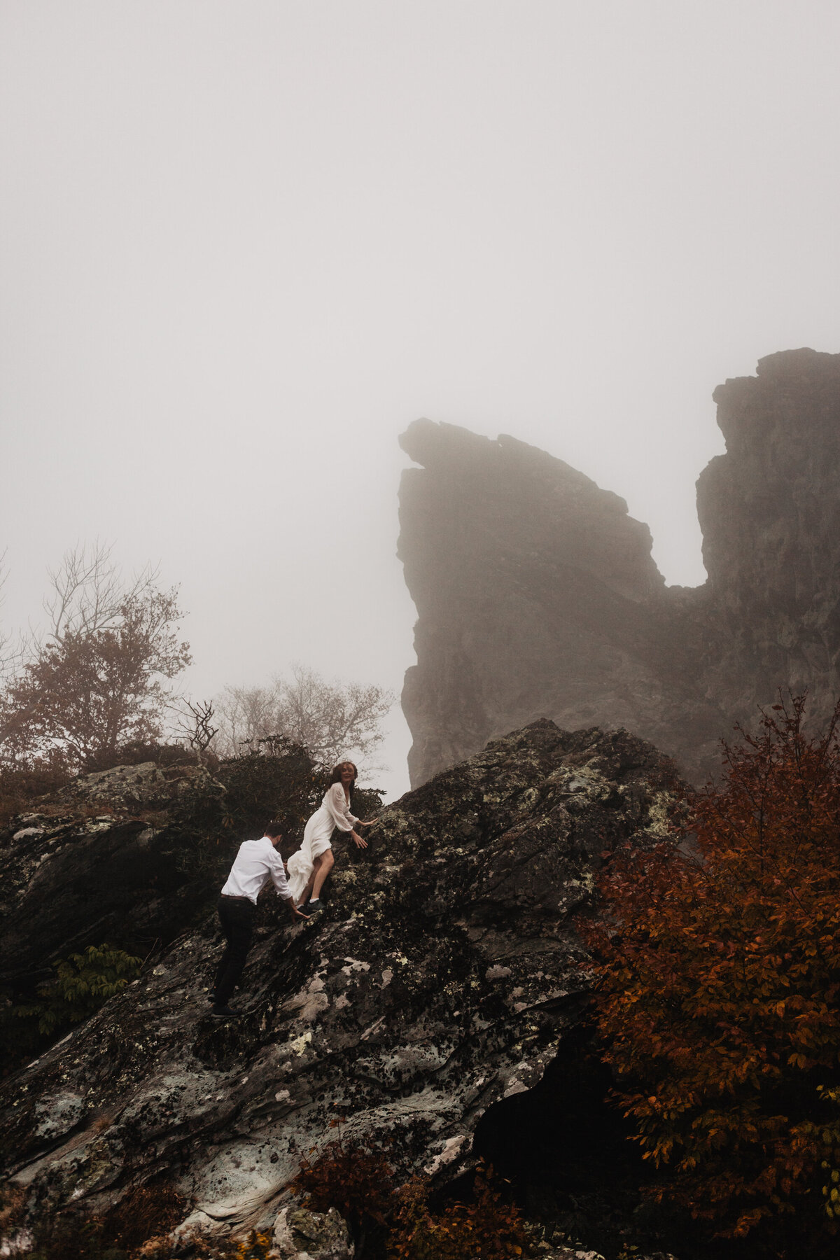 Smoky Mountain elopement with bride and groom rock climbing a mountain