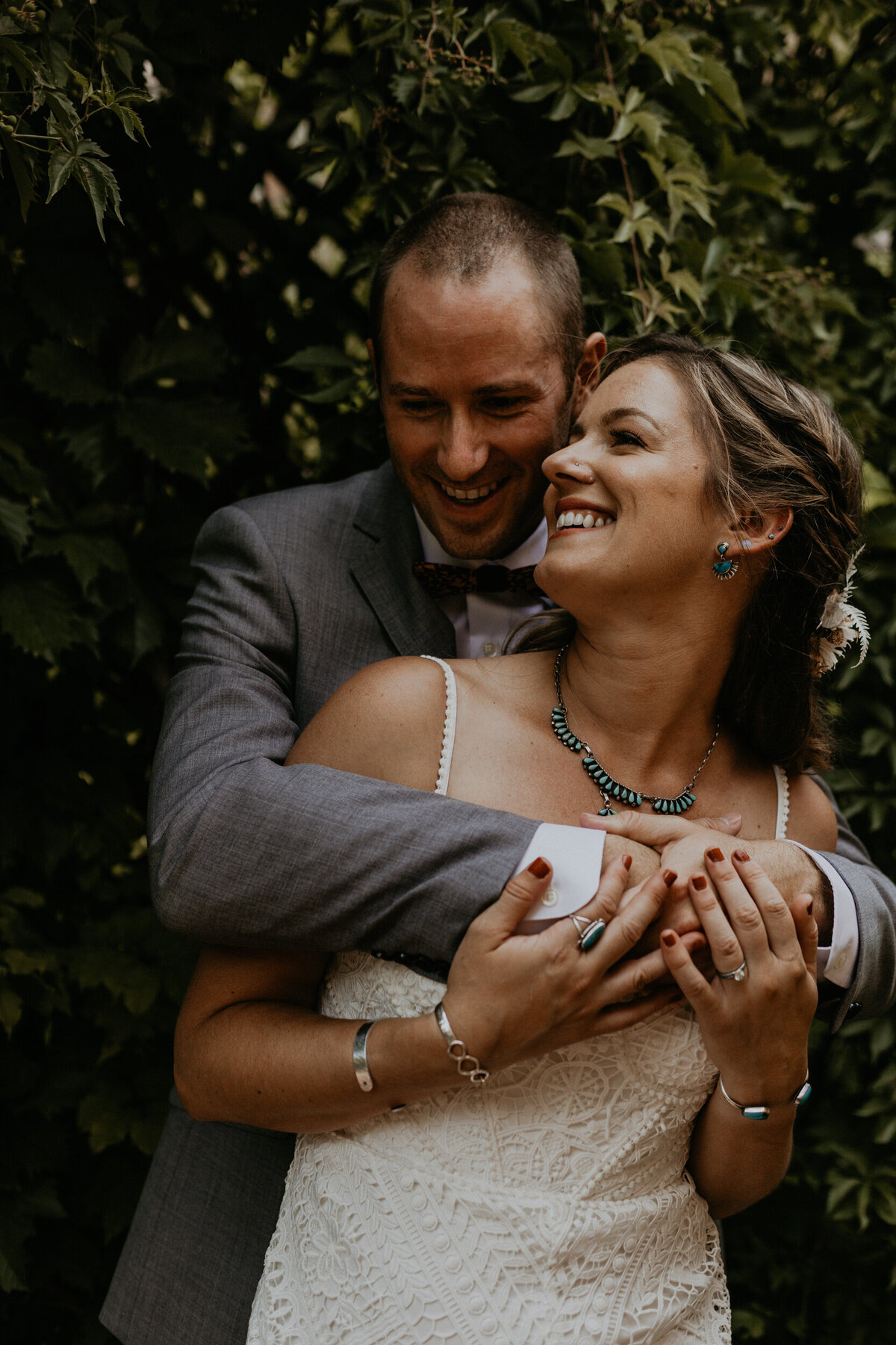 bride and groom standing together in a garden