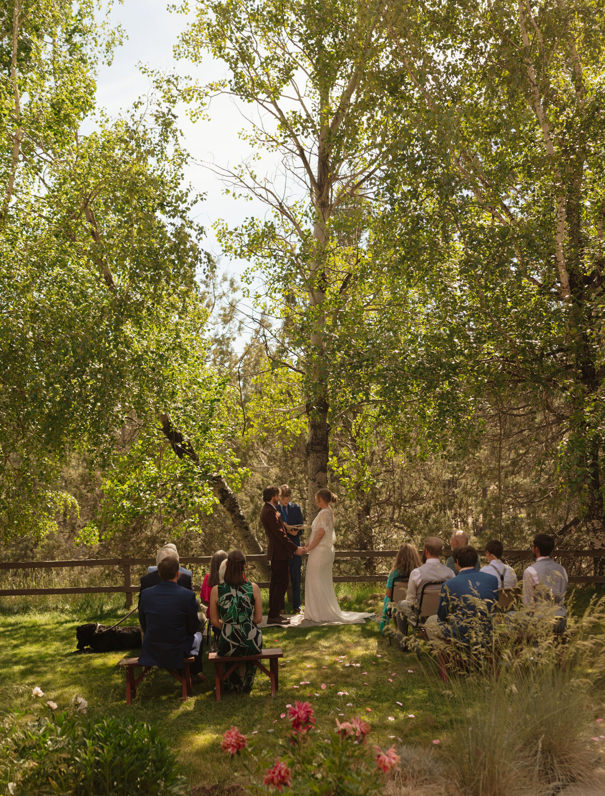 friends and family gather around the bride and groom during a small, intimate elopement session among nature in Bend, Oregon