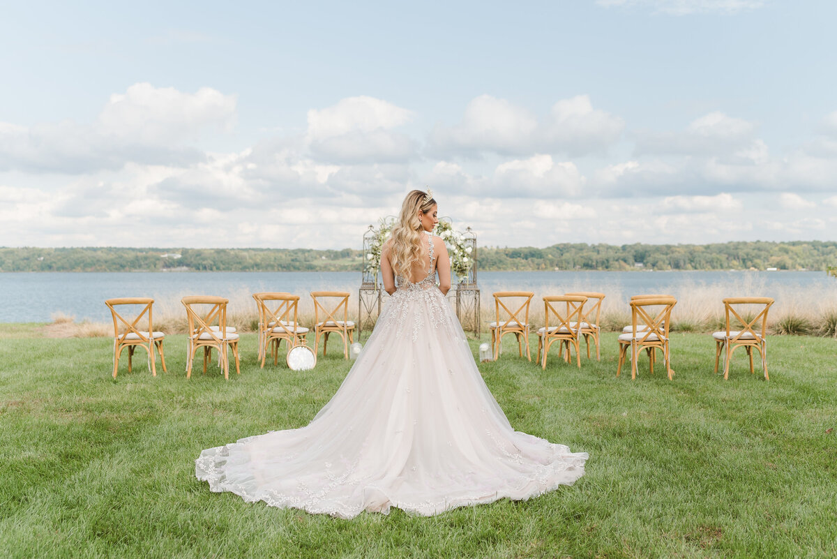 NJ wedding photographer captures a photo of a bride from behind wearing a crown at a venue with waterviews