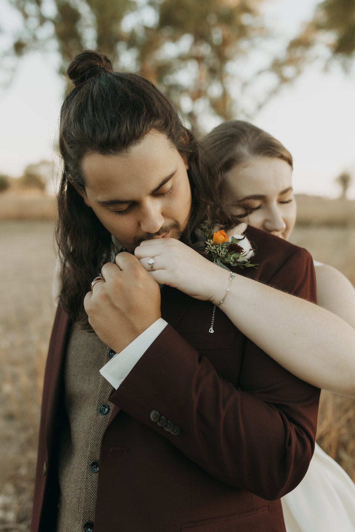 groom kissing brides hand