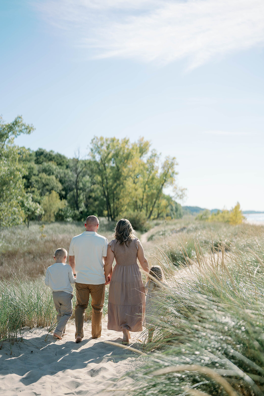 The Loza family walking the sandy trail at Weko Beach during their summer mini session.