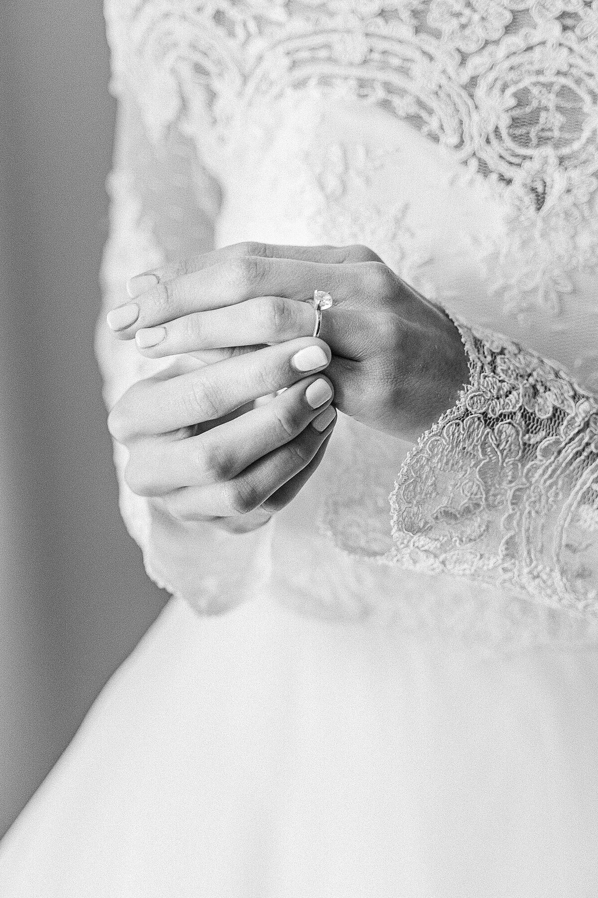 Bride adjusting her engagement ring before her intimate wedding ceremony