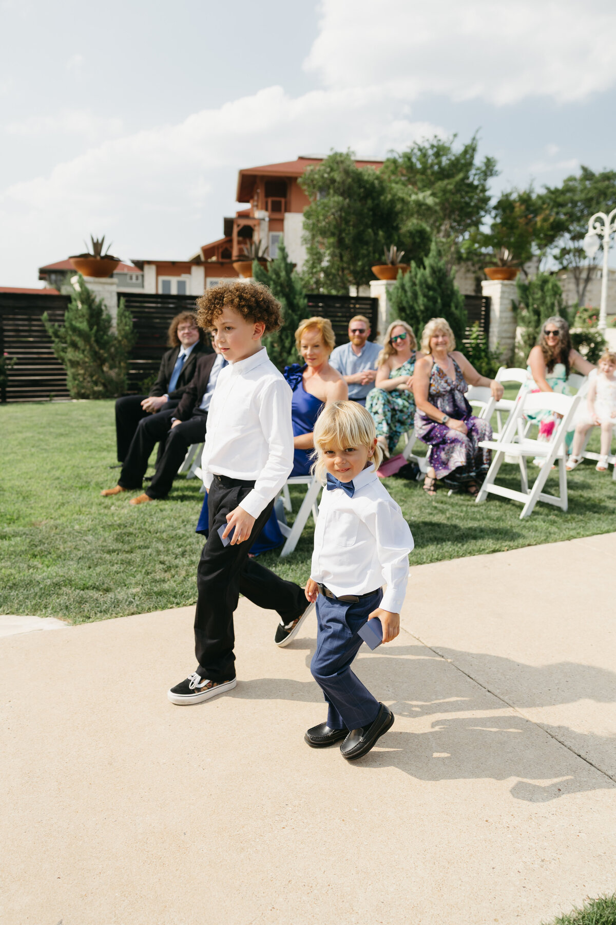 ring bearer walking down aisle with wedding rings in austin texas