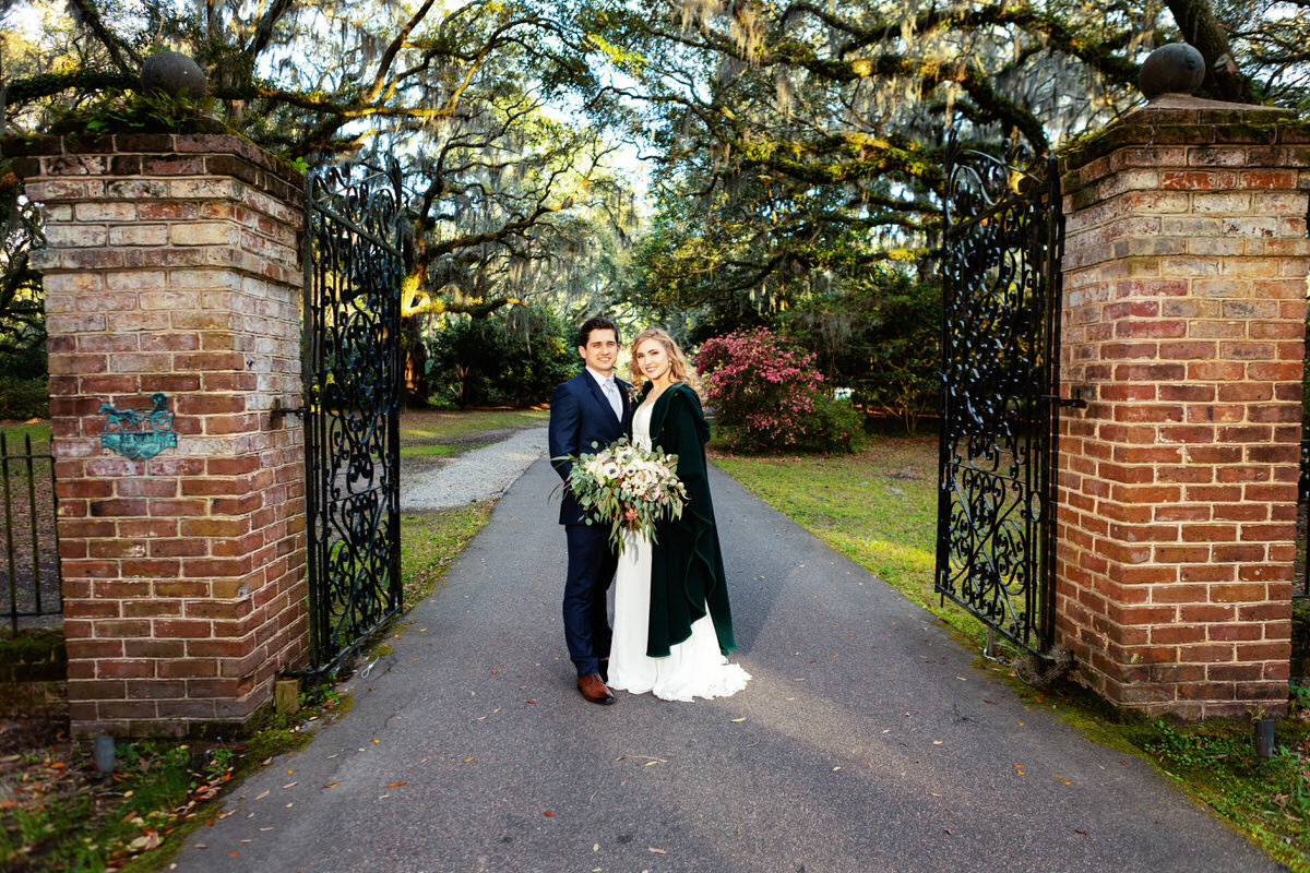 Charleston Wedding Photographer Legare Waring House gate portrait with bride and groom