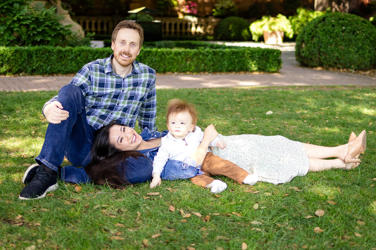  Happy young family smiling at the camera in natural light during a San Francisco Peninsula photoshoot