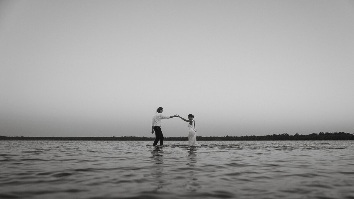 couple in the lake holding hands