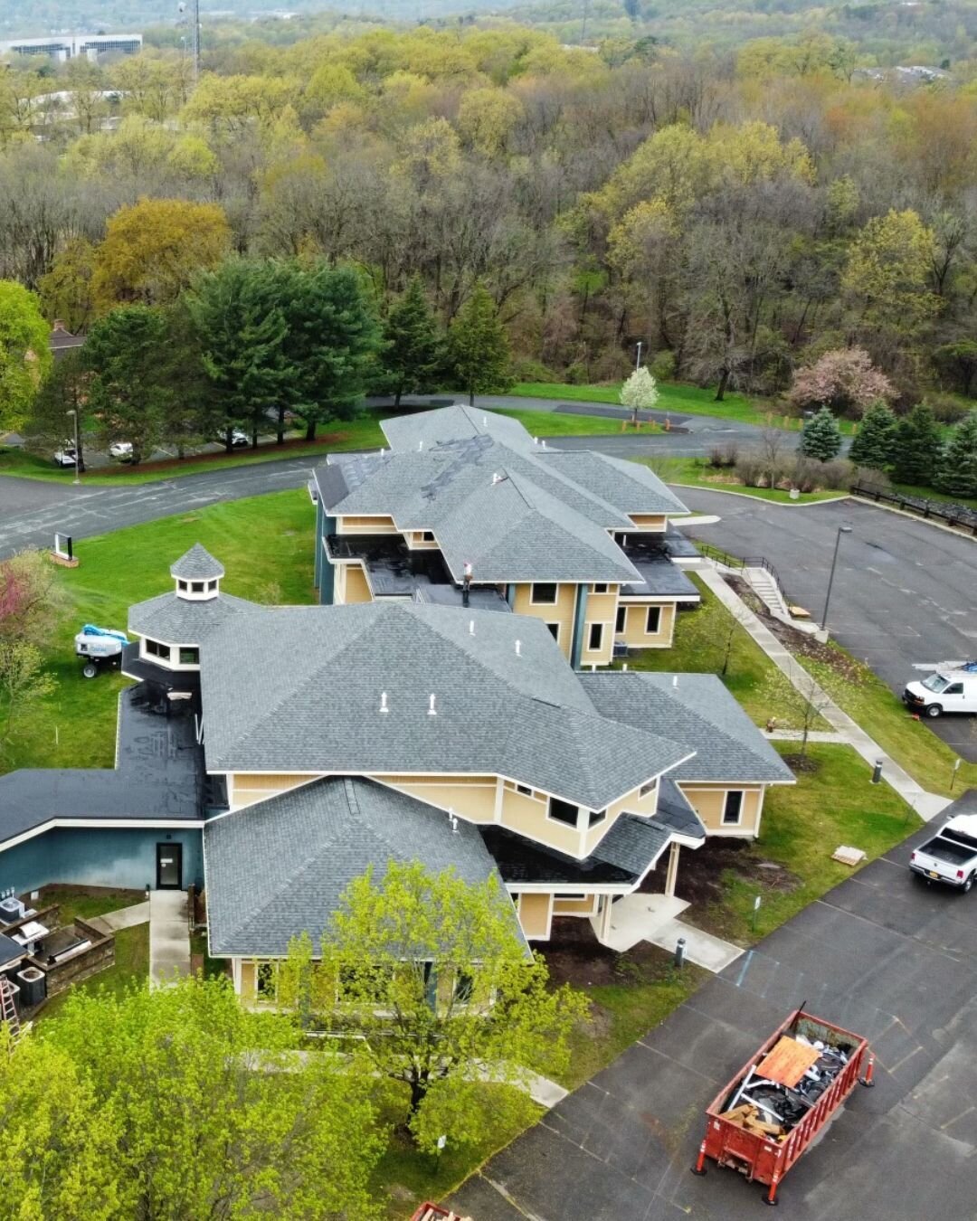 Aerial view of apartment buildings with asphalt shingle roofs