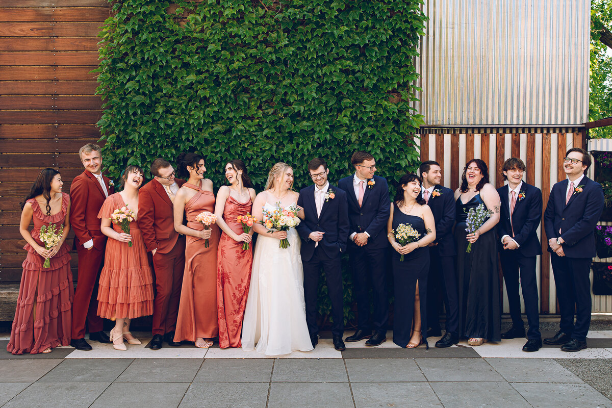 A couple and their wedding party share a laugh during their wedding at The Joinery in Chicago