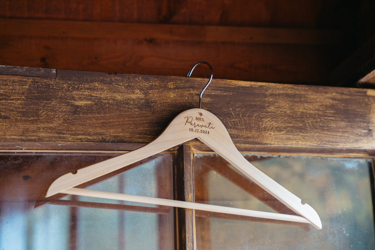Wooden hanger with engraved bride’s name and wedding date
