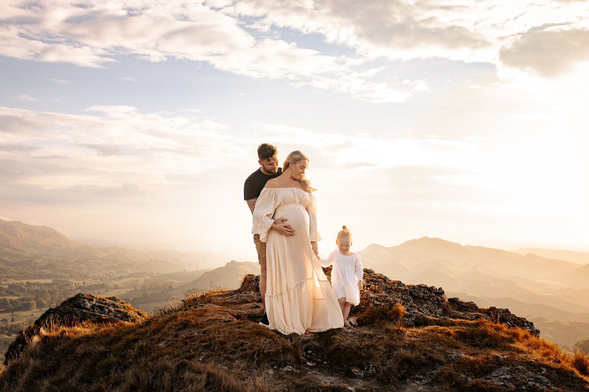 Hawke’s Bay family photographer specialising in maternity, newborn, and family portraits — mountain location session with expecting mother and family captured by Lightkeeper Photography, Napier and Hastings.