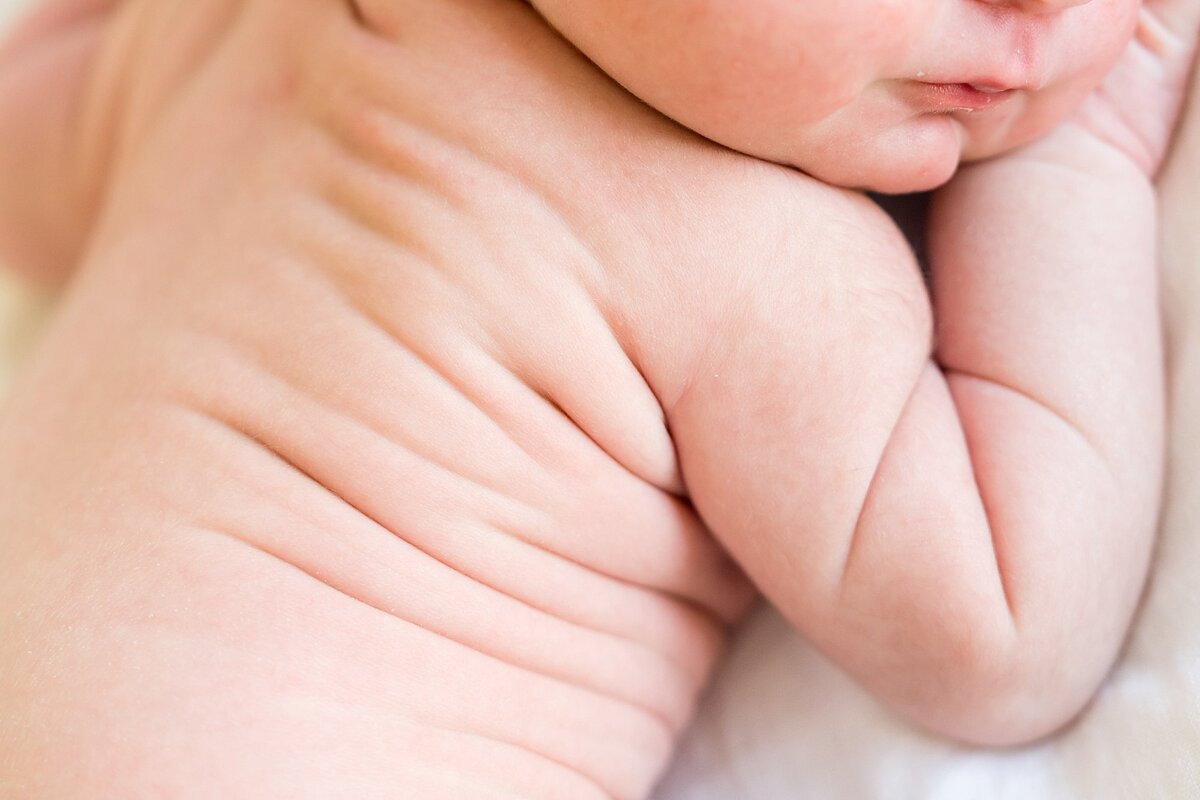 Family holding their baby during a lifestyle newborn session in Austin.