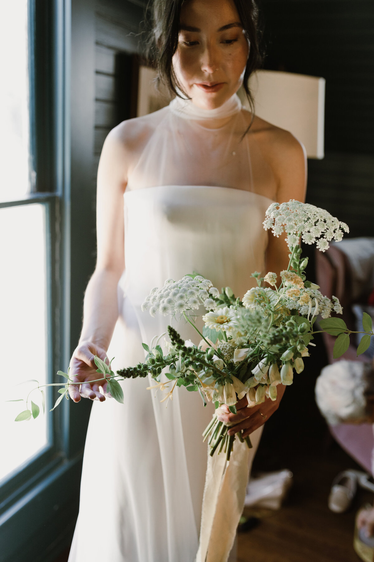 Bride holding bouquet of ivory florals for wedding at  Mattie's Austin