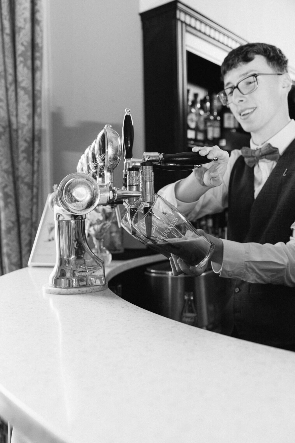 A black adn white photo of the barman at Luttrellstown Castle during a wedding