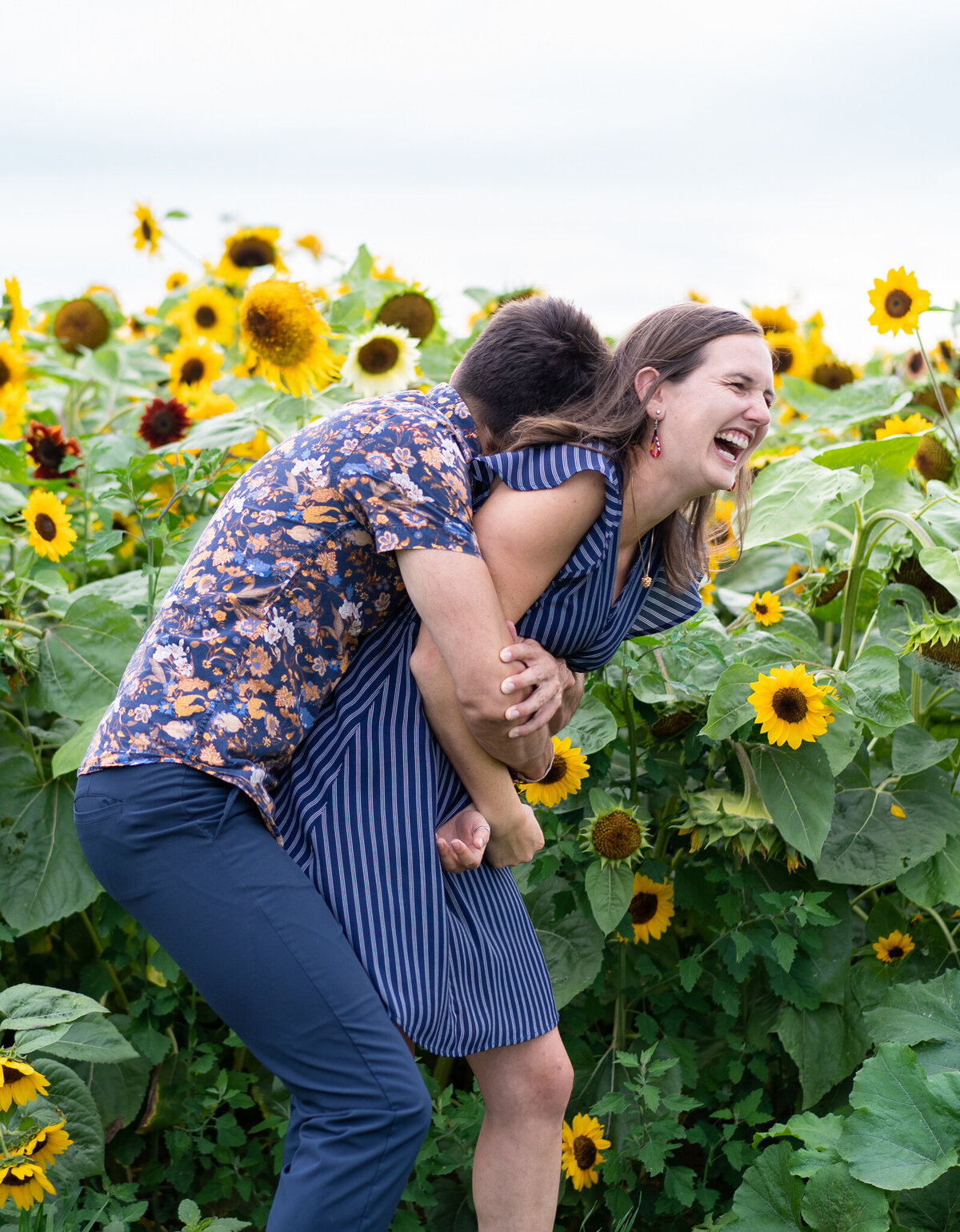 Anthony Martino giving his girlfriend, Eva, a big hug from behind at S'miles of Sunflowers at Lynd Fruit Farm in Pataskala, Ohio.
