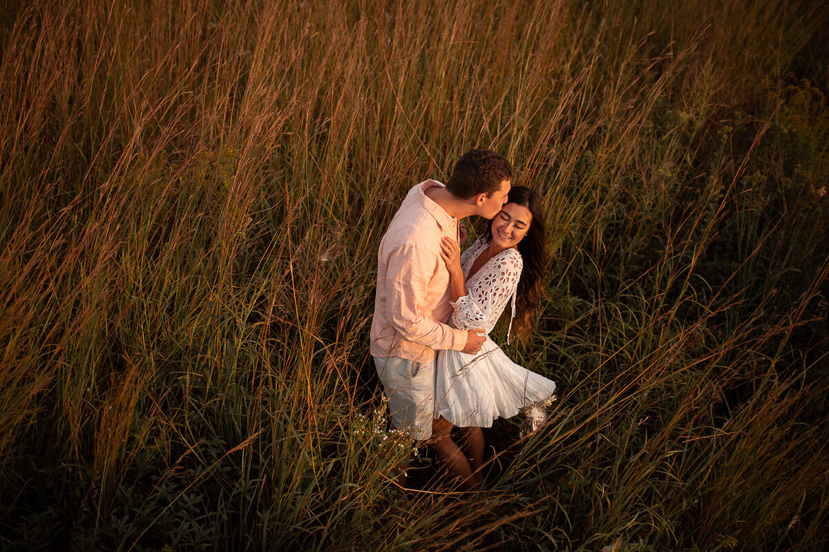engagement-session-outdoors-nature-field-laughing-couple