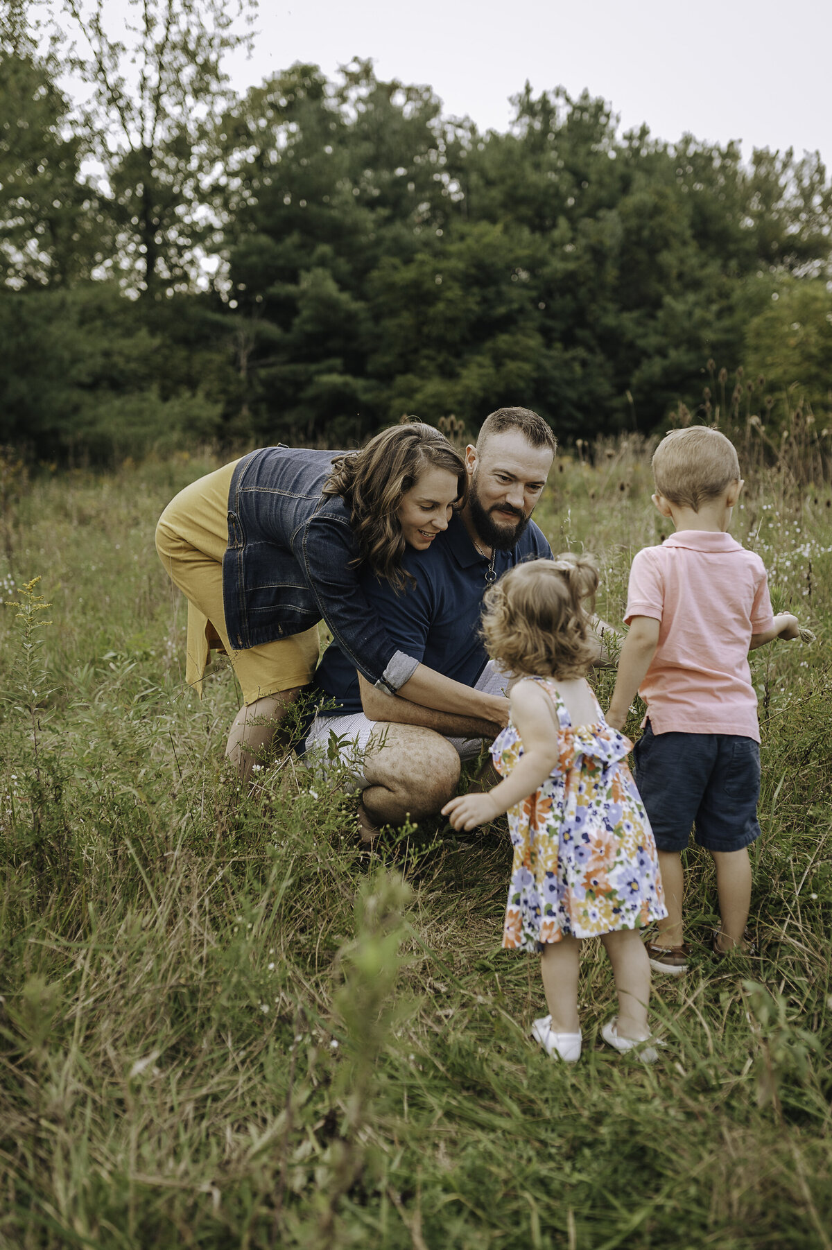 Verona B Photography captures a beautiful summer family photo of a dad, mom and their two kids at Silver Creek Metro Park in Norton, OH while they are picking flowers. The love the family had for each other was evident and it was so wonderful to capture this family in this beautiful lake setting near Akron.