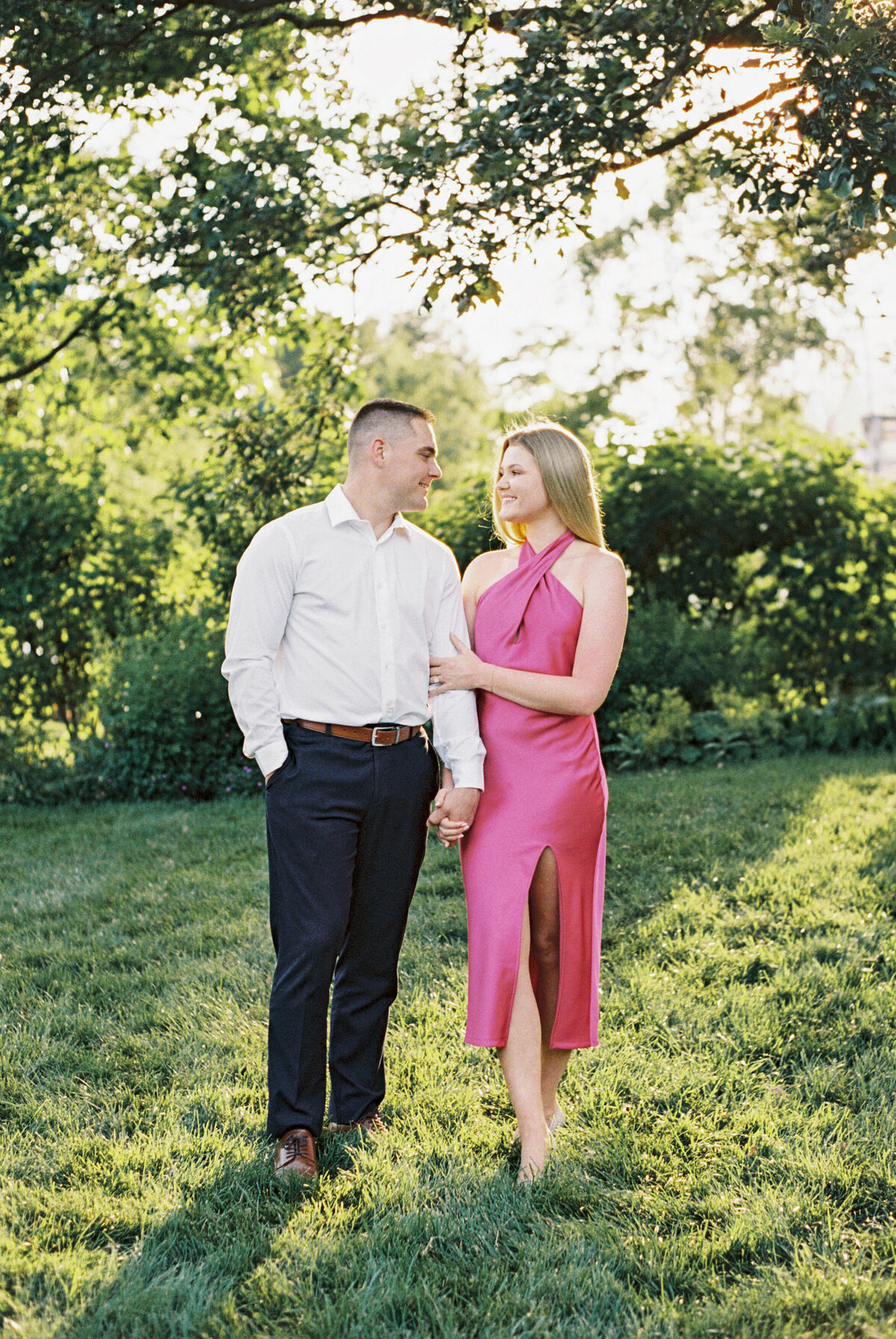 Smiling couple shares a moment during sunny engagement session in Columbus, Ohio.