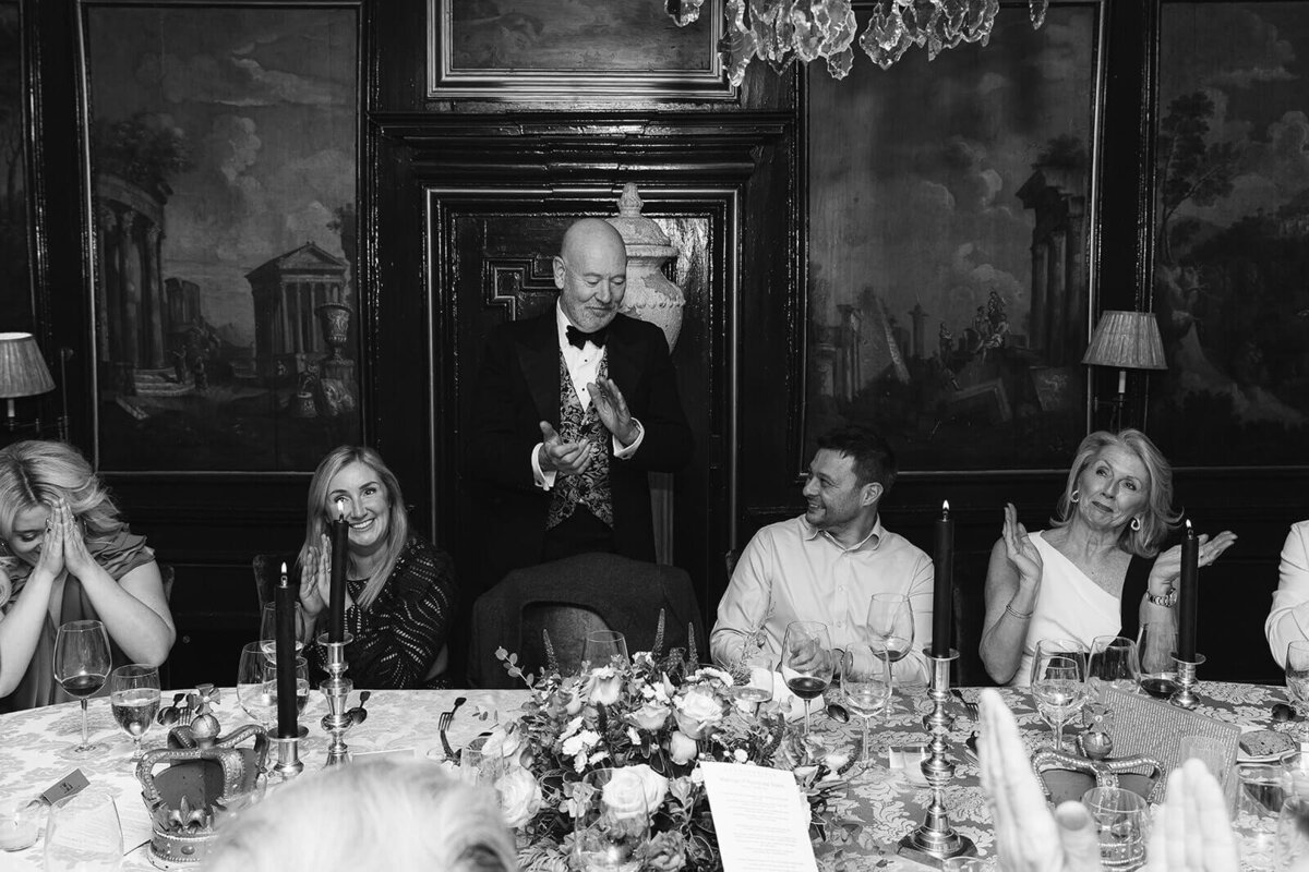 A guest addresses the other guests at an intimate wedding at Prestonfield House