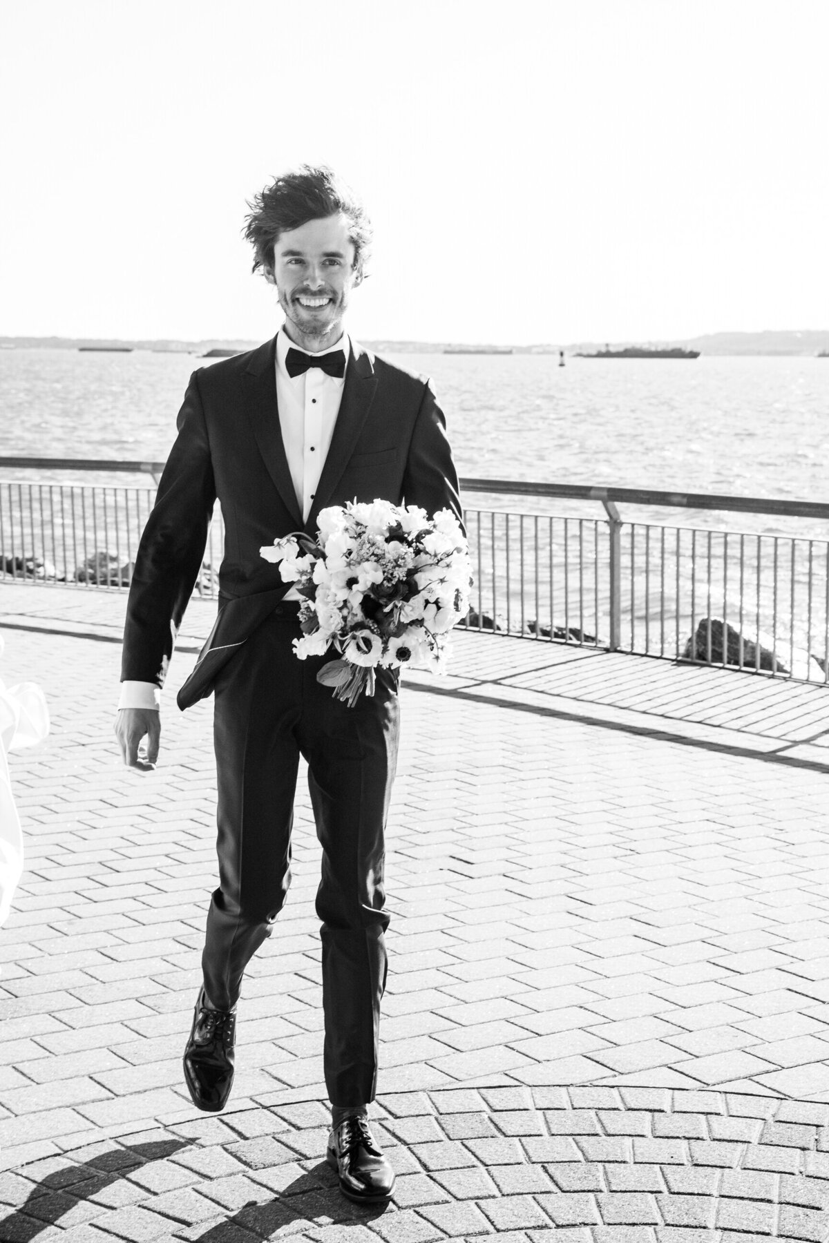 groom holding flowers