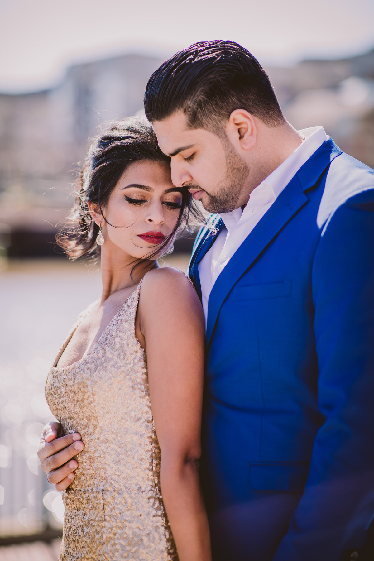 A couple sharing a moment by the riverwalk in new jersey during their engagement session in formal clothing