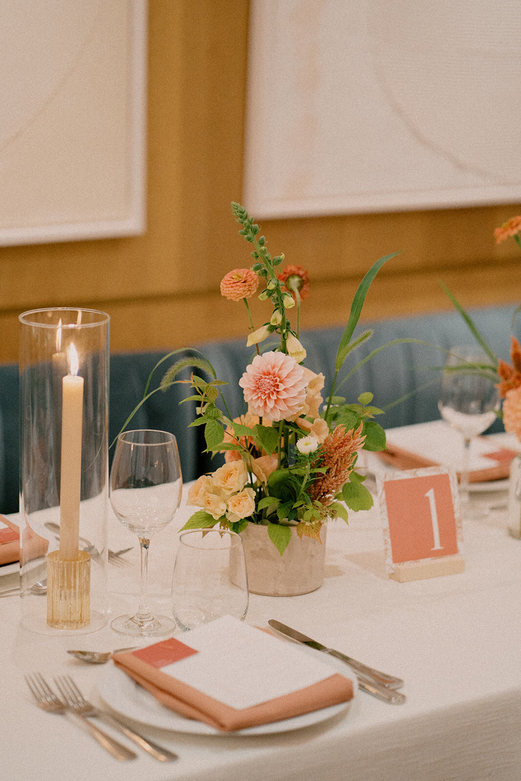 Small, colourful wedding centrepiece at Restaurant Beatrice featuring bright spring flowers. 