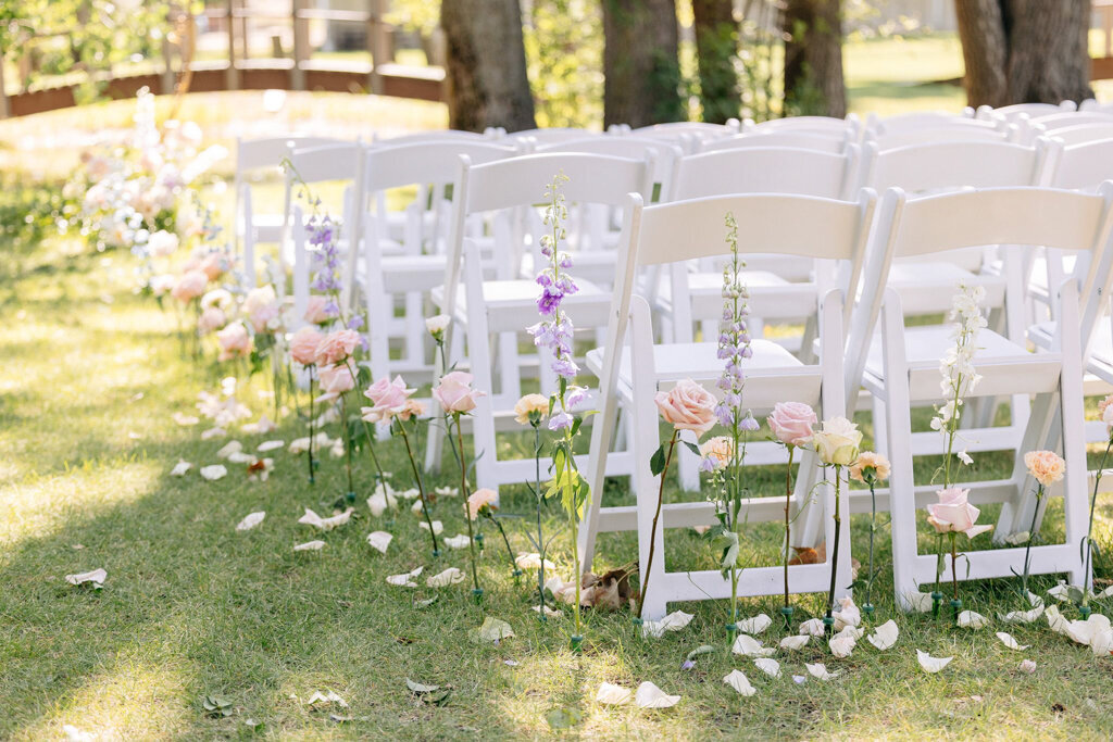 Elegant wedding ceremony with floral lined aisle, captured by Lorissa Lee Photography. Featured on Brontë Bride.