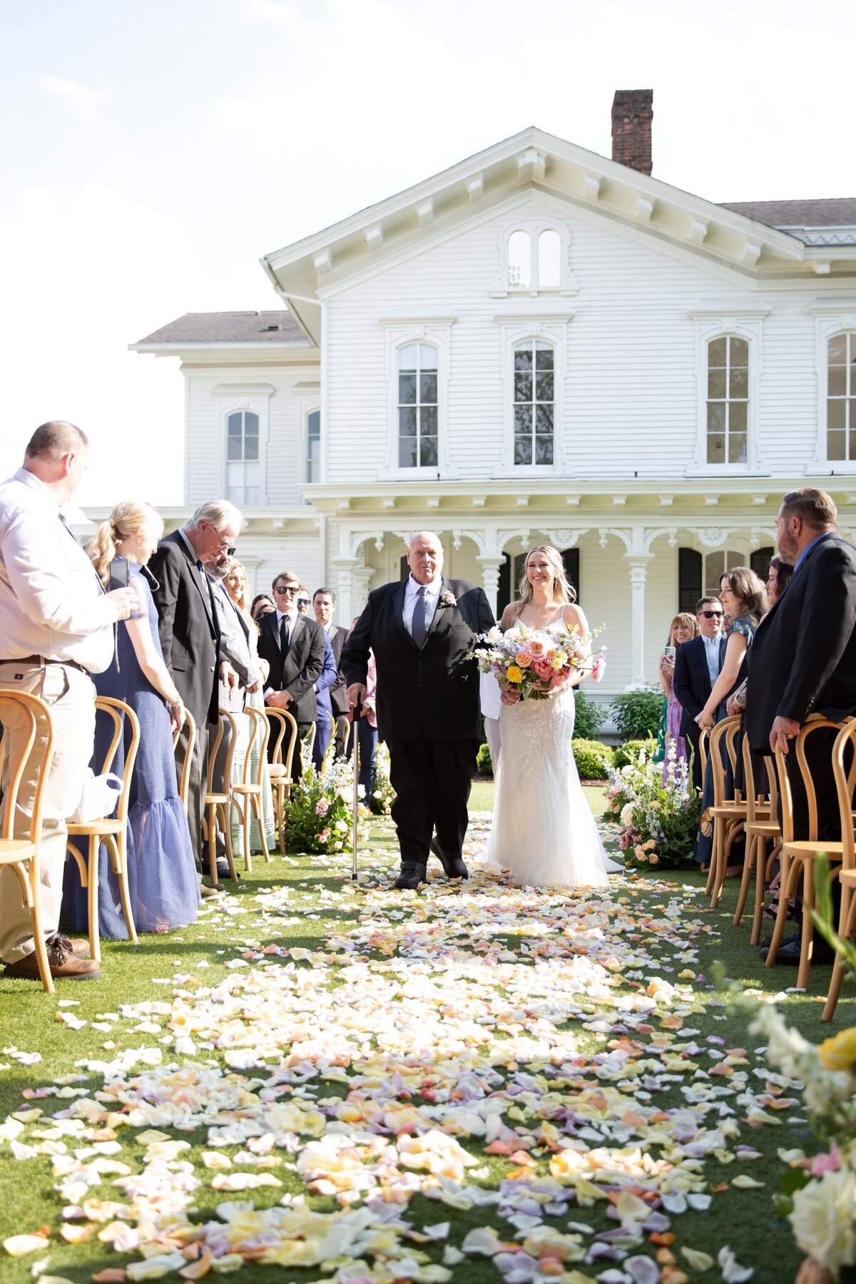 Bride walking down the aisle at an outdoor wedding at a wedding venue in downtown Raleigh, NC.