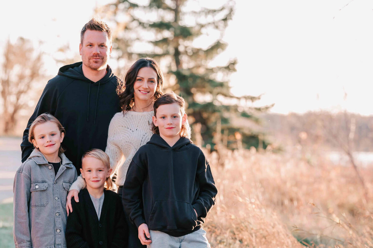 A family of 5 stand in a group