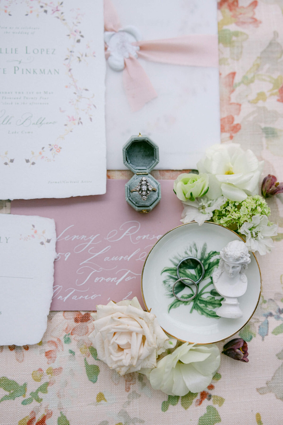 A wedding day photo of the brides wedding ring and wedding invitations at Villa Balbiano on Lake Como in Italy