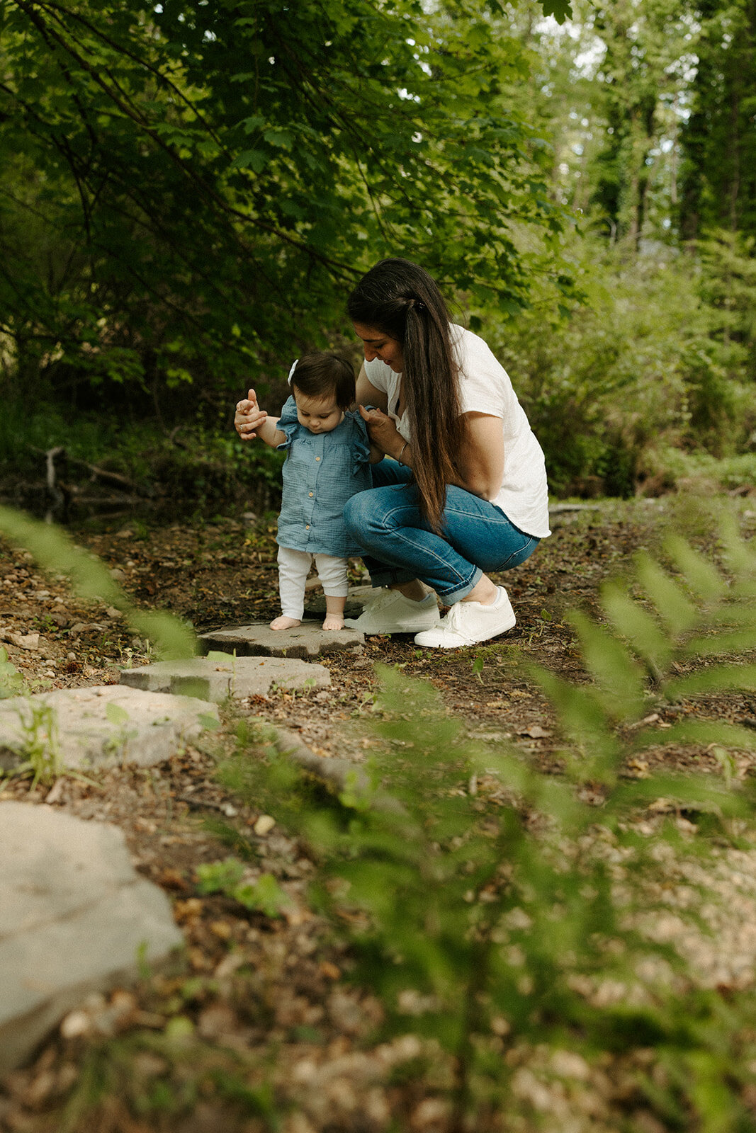Mom and daughter playing in a creek by a Midlothian VA greenhouse 