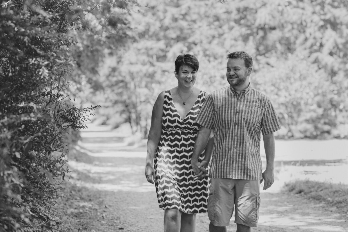 A couple holding hands and walking along a path