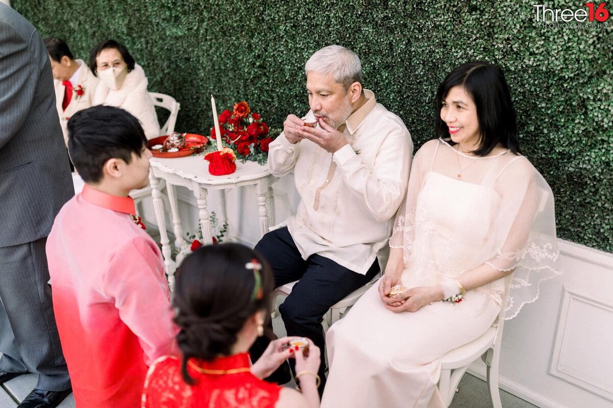 Father takes a sip of the tea at a Chinese wedding