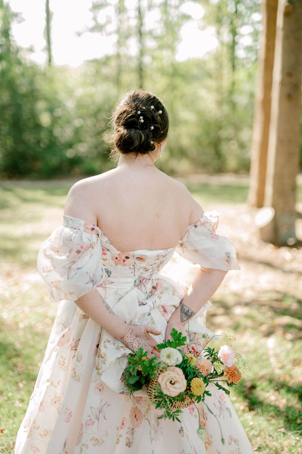 bride standing while holding her bouquet behind her back 