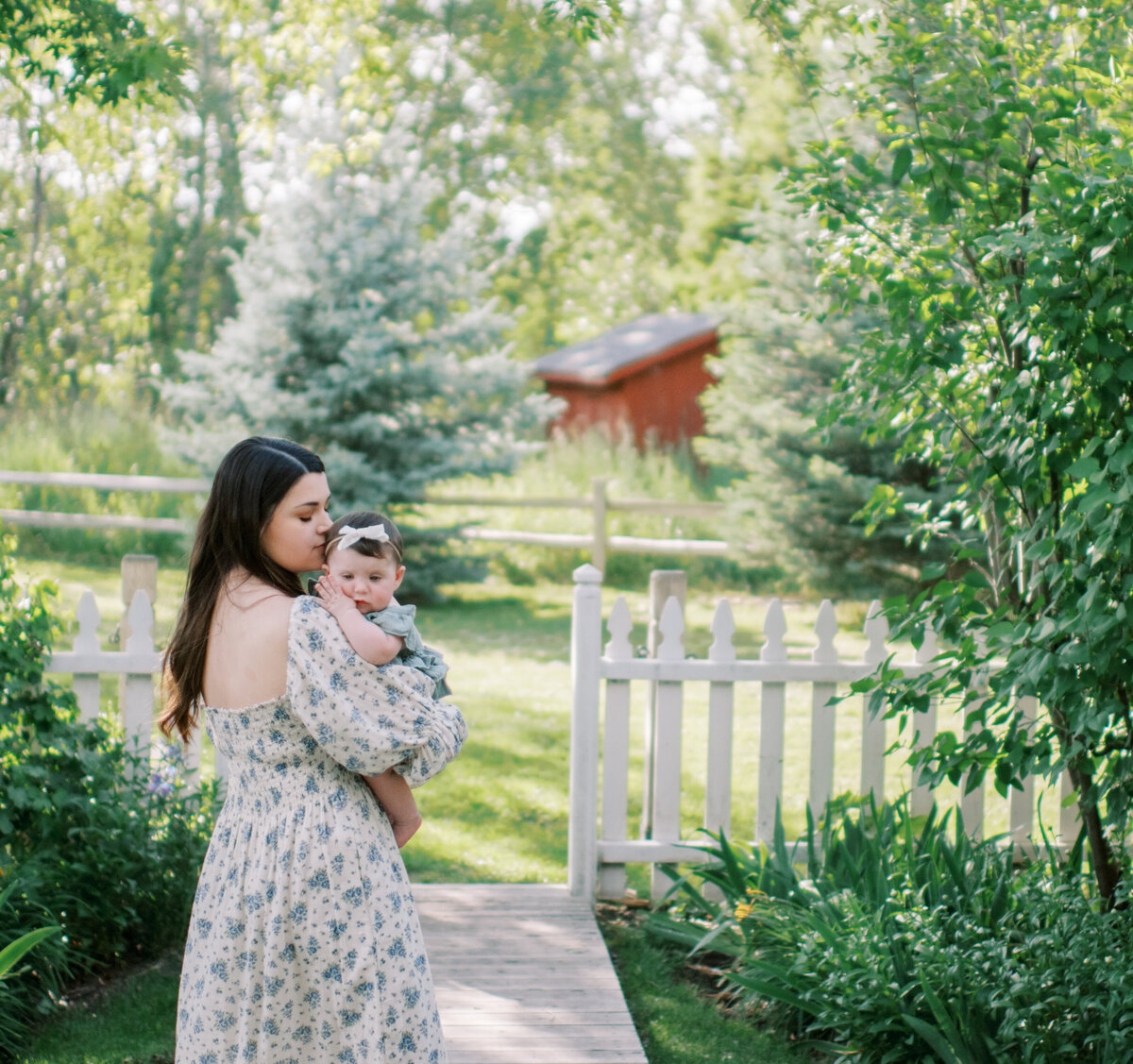 mom with baby girl walking in garden photos