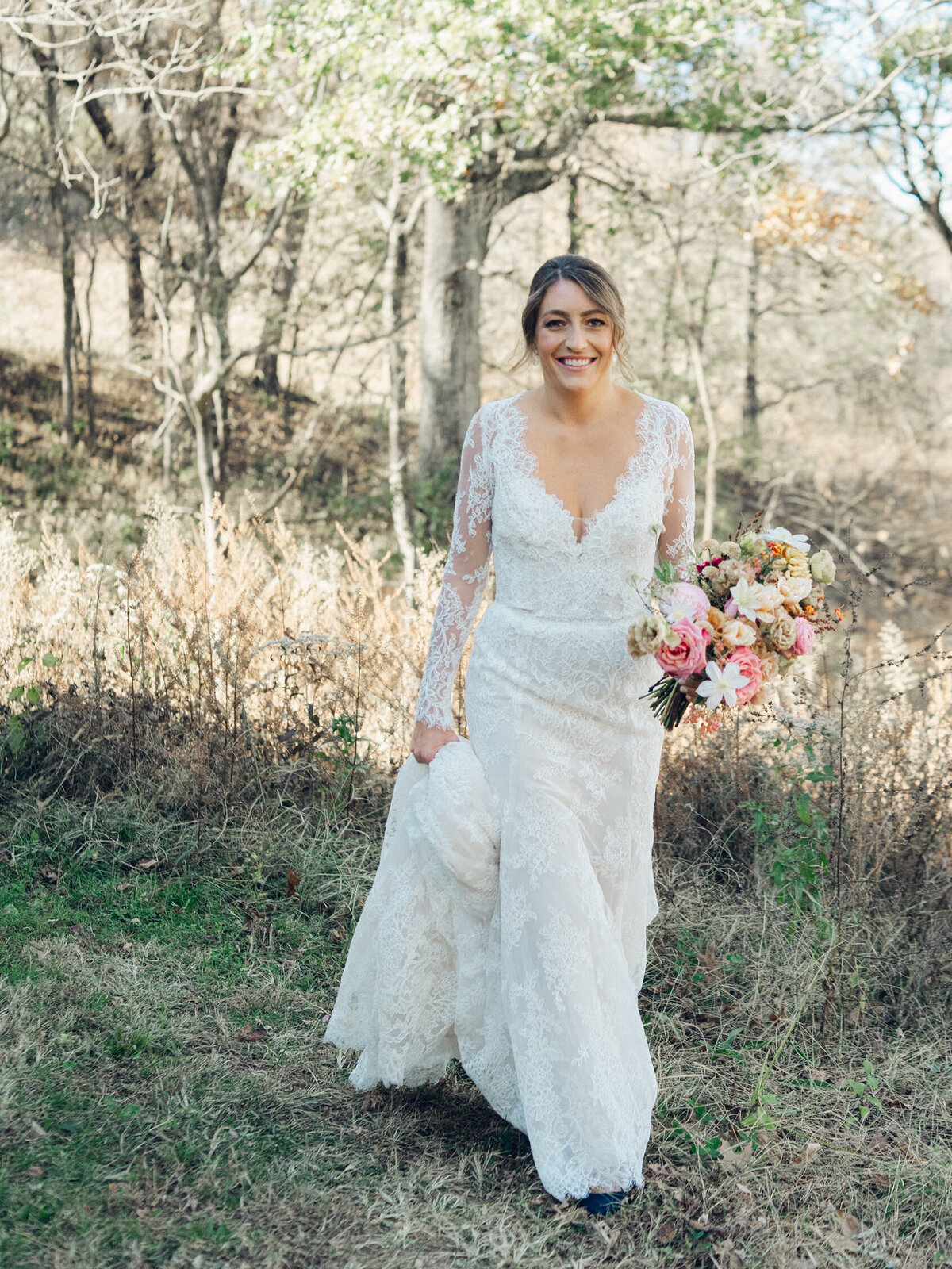 Whimsical bridal bouquet in unique fall tones caramel, dusty rose, peach, tangerine, and copper. Fall floral bouquet with roses, ranunculus, mums, fruiting branches, and clematis. Medium sized bridal bouquet with fall colors. Destination wedding outside Nashville, TN. Design by Rosemary & Finch Floral Design in Nashville, TN.